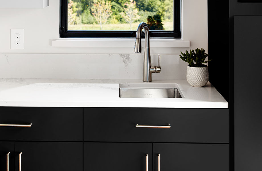 Modern kitchen sink with black cabinets