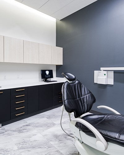  office with black and white chair and modern cabinets .